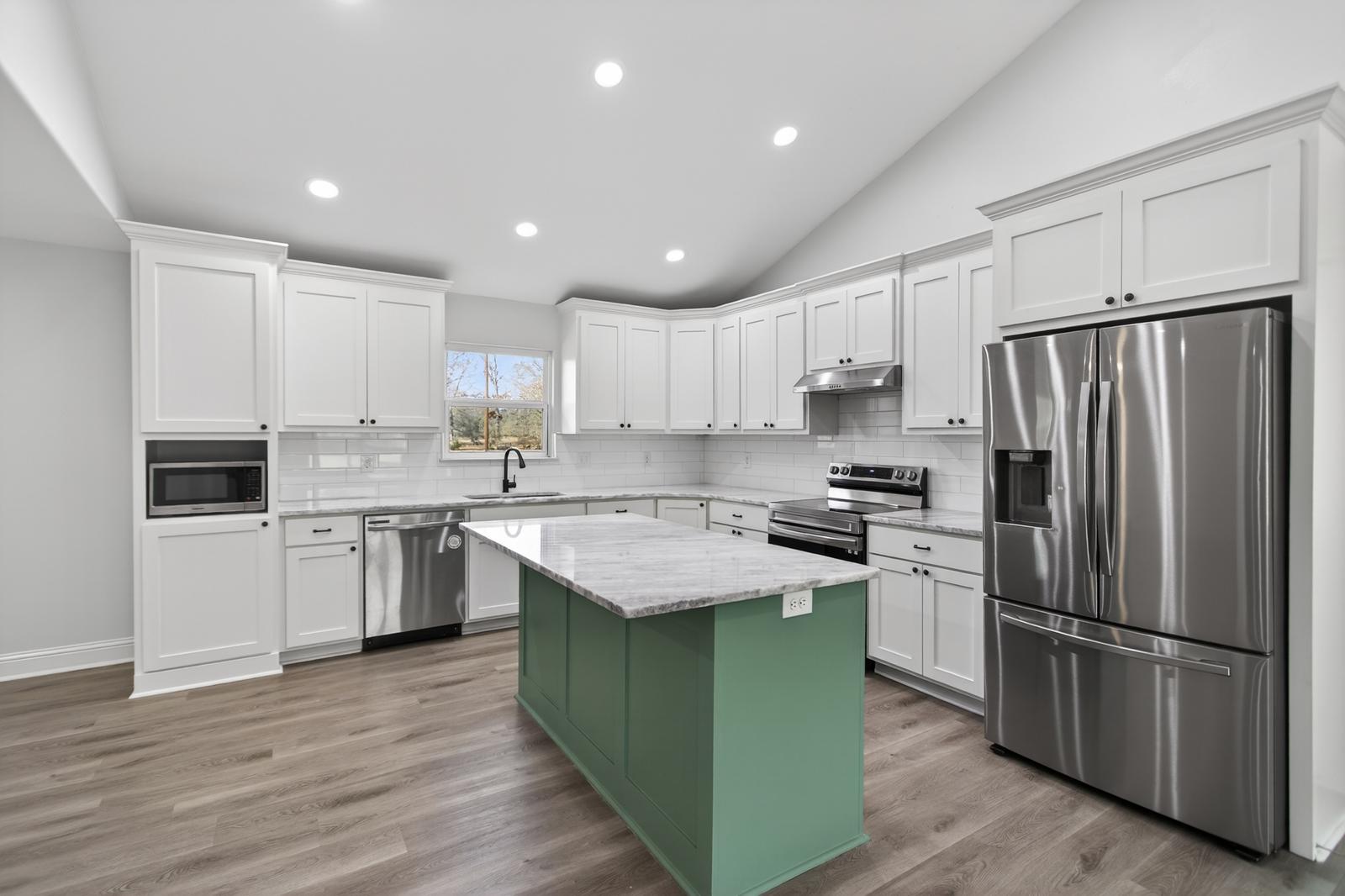 Bright kitchen with a green island
